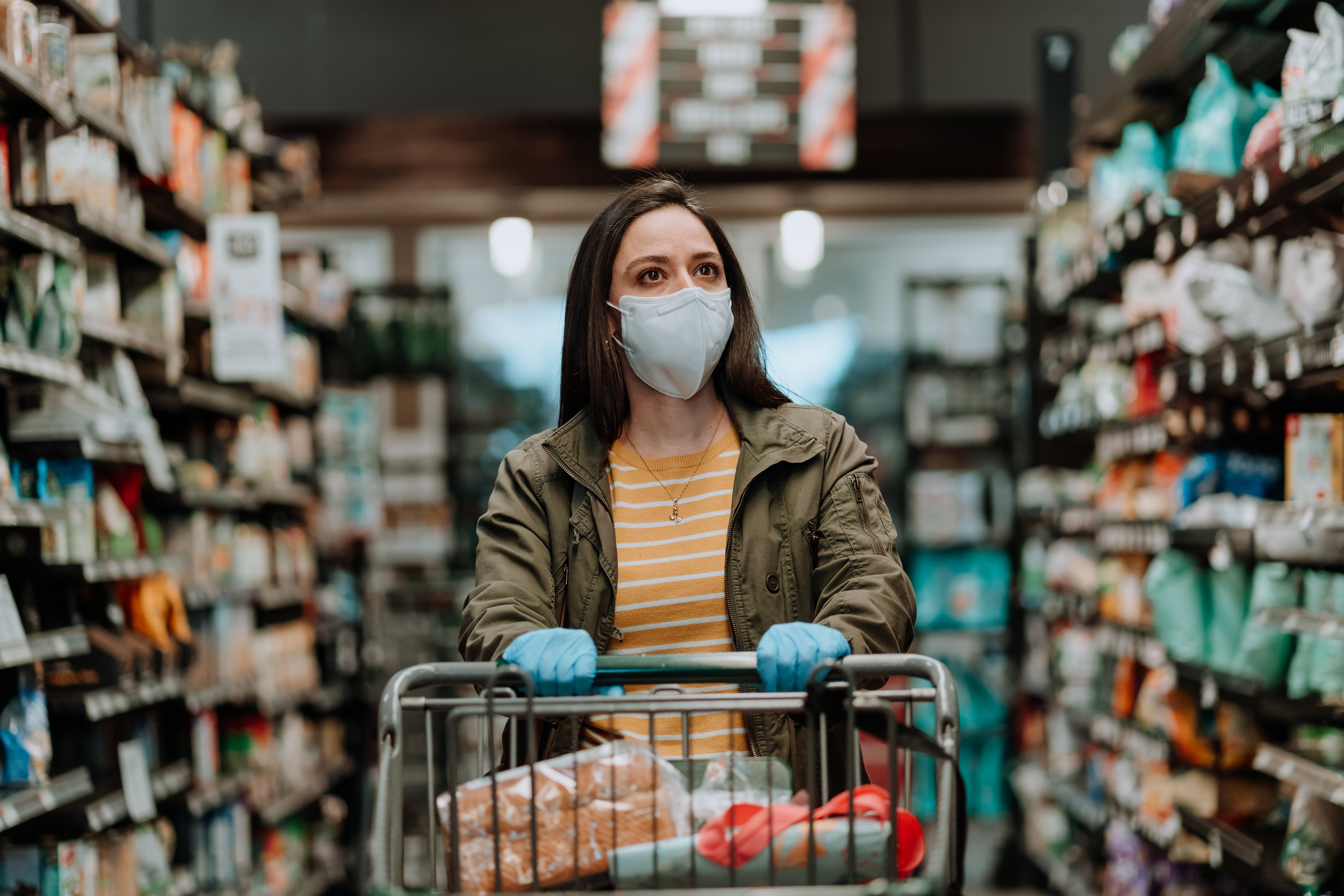 Woman in mask and gloves at the grocery store